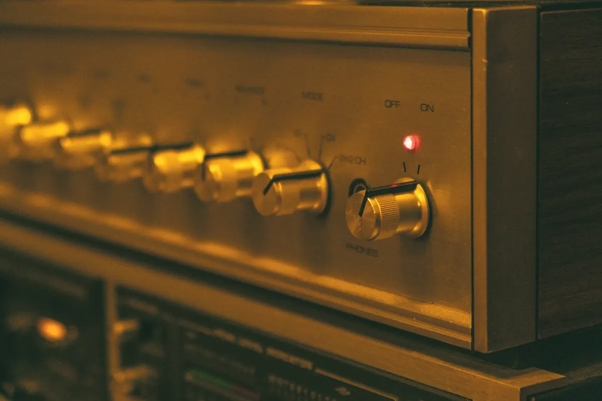 Brushed gold front panel of an integrated amplifier with rotary controls and a red power indicator
